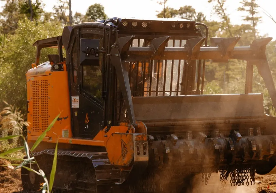 Close view of a forestry mulching head with its teeth and chain guards